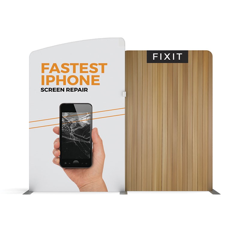 A hand holds a cracked iPhone on a 10ft Waveline Media M-Series Kit 03 display by Affordable Exhibit Displays, with FASTEST IPHONE SCREEN REPAIR text beside a wood-paneled wall labeled FIXIT.