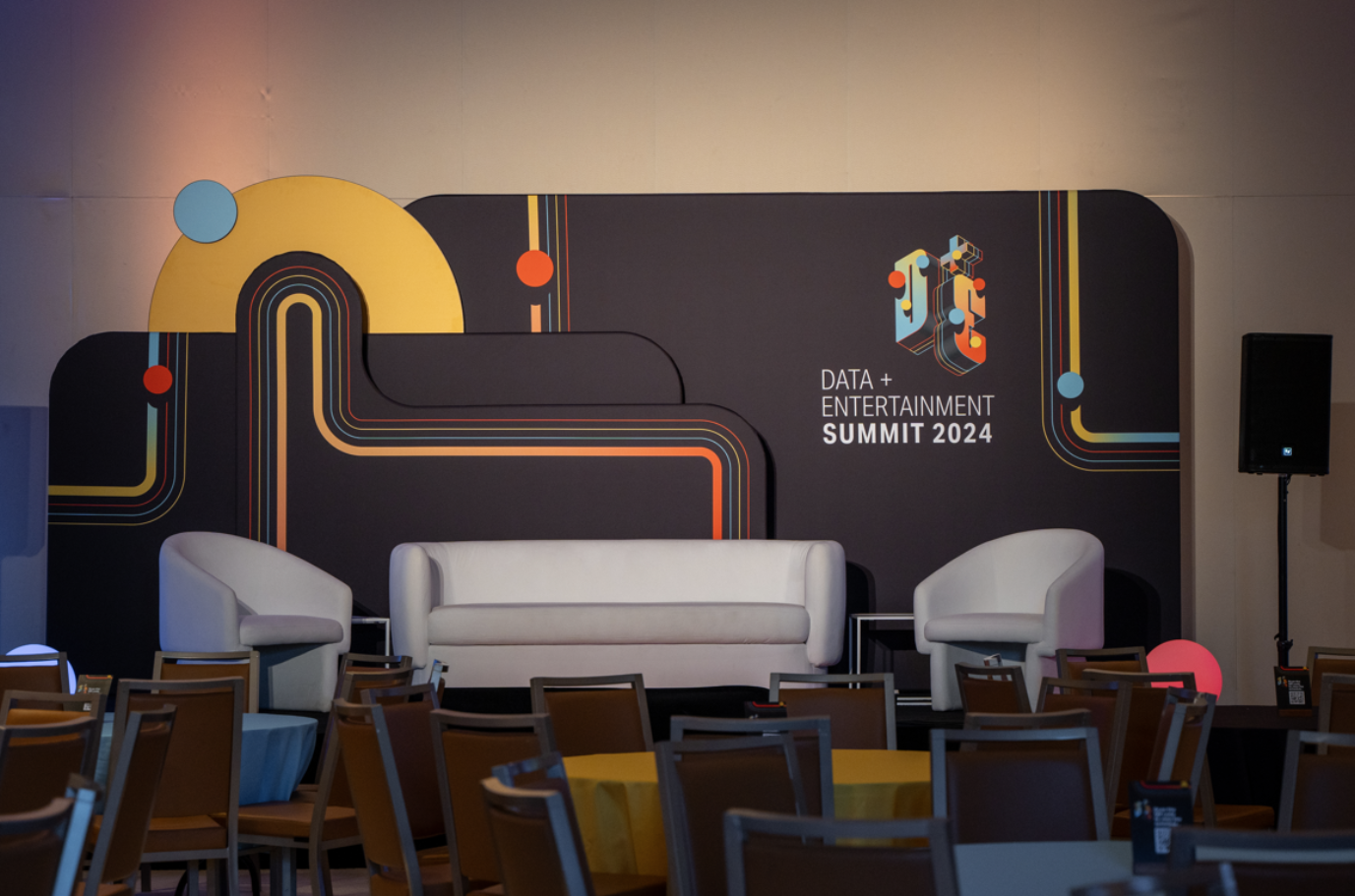 20ft stage event setup with custom printed pillowcase tubular tension fabric displays for Data & Entertainment Summit 2024.