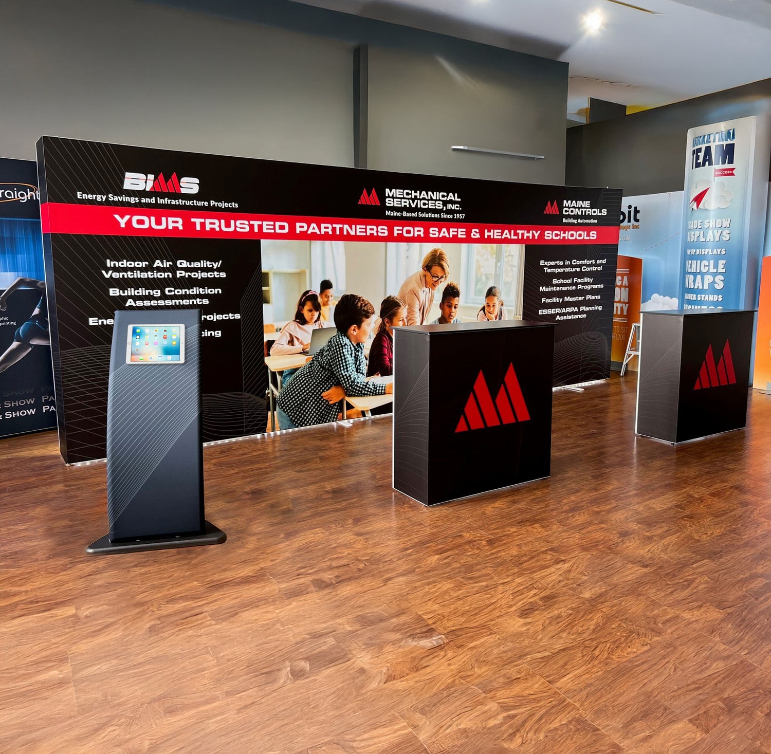 20ft Embrace backlit tension fabric backwall kit with backlit podiums and an interactive ipad stand.