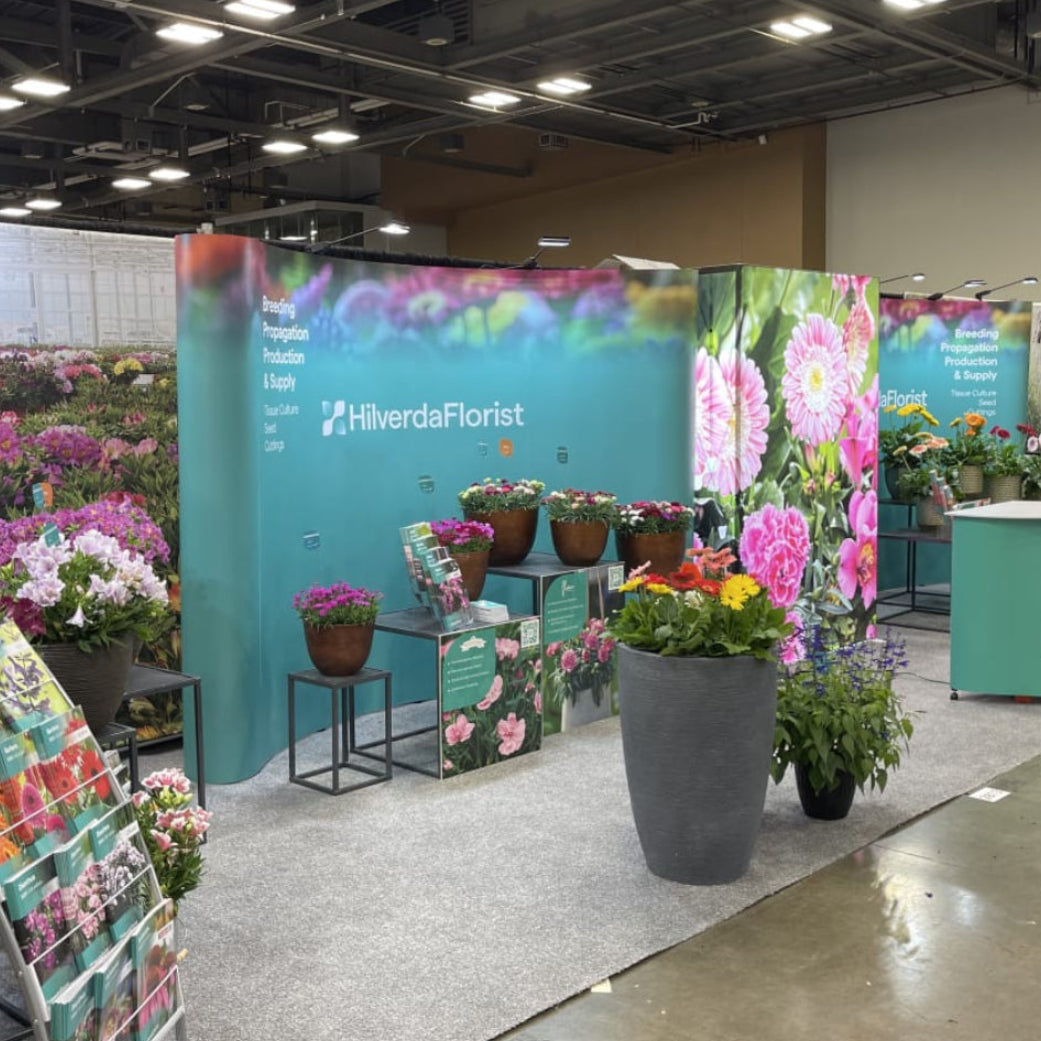 Two 10ft wide pop up displays with a center SEG backlit tower display by Affordable Displays.