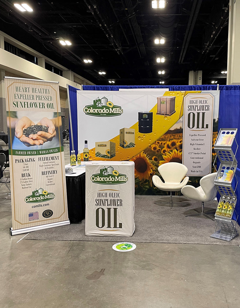 Colorado Mills sunflower oil t10ft rade show display at a trade show with promotional materials and branding.