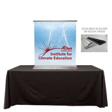A table top display banner stand on a white backdrop. 