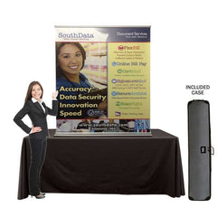 A photo of a table top display banner stand with a woman and case infront of the table on a white background. 