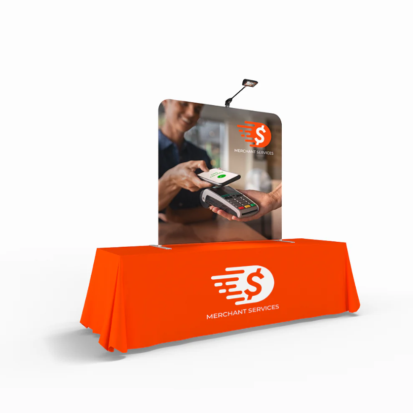 A left side angle of a table top display with lights attached and an orange table cover. 