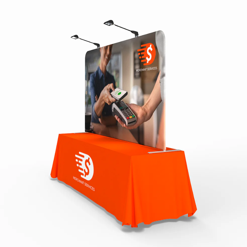 A different angle of a table top display with lights attached and an orange table cover. 
